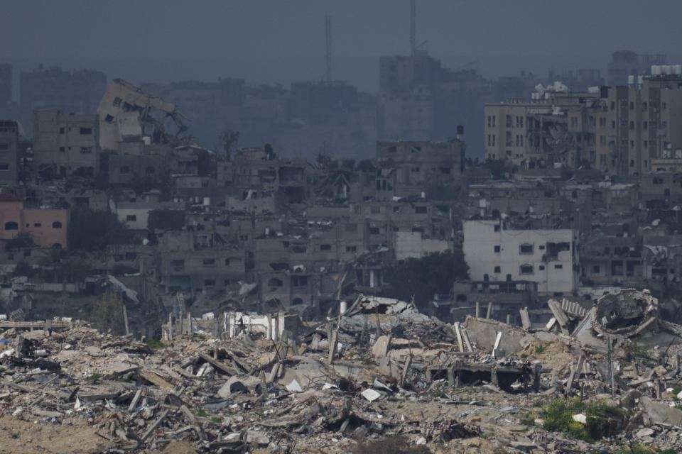 Destroyed buildings stand in the Gaza Strip as seen from southern Israel, Thursday, Feb. 15, 2024. (AP Photo/Leo Correa)