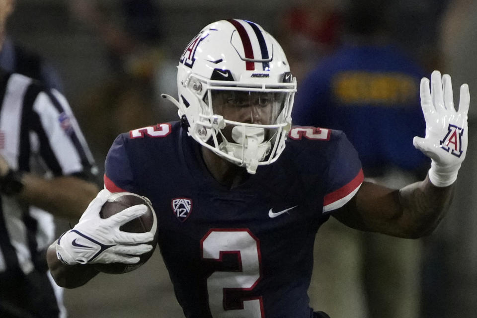 FILE - Arizona wide receiver Jacob Cowing (2) tries to fight off a defender in the first half during an NCAA college football game against Colorado, Saturday, Oct. 1, 2022, in Tucson, Ariz. Arizona opens their season at home against Northern Arizona on Sept. 2. (AP Photo/Rick Scuteri, File)