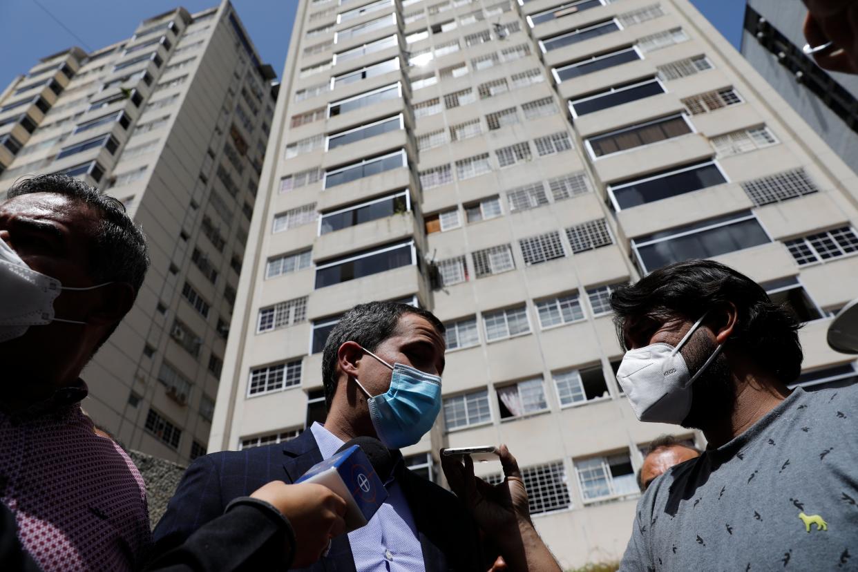 Opposition leader Juan Guaido speaks to the press at his residential building in Caracas, Venezuela, Monday, July 12, 2021. Guaido said security forces threatened his driver when he and his driver arrived home Monday. (AP)