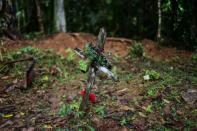 A cross has been placed at the sight of the mass grave where seven people -- six children and a pregnant woman -- were found buried