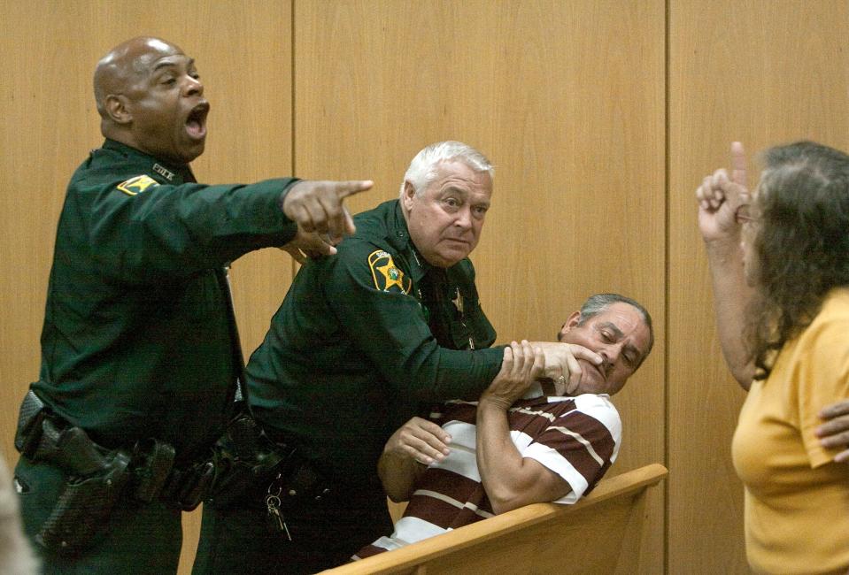 Former Ledger photographer Michael Wilson won a national award for his photos showing Polk County Sheriff's Office bailiffs responding to family members of a victim in the Leon Davis Jr. murder trial in 2010. Wilson, a staff photographer for 28 years who also produced a fishing report in recent years, died Sunday at age 61.