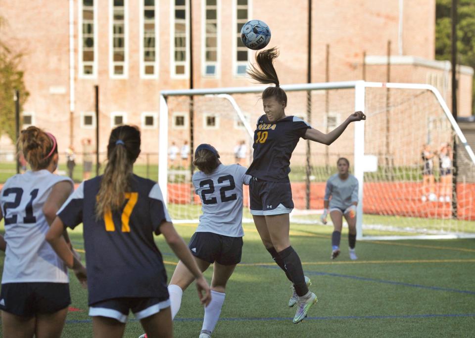 Notre Dame Academy's Lola Paradis, right, heads the ball as Cohasset's Megan Smith, left, during girls high school soccer at Notre Dame Academy in Hingham, Wednesday, Sept. 14. 2022.