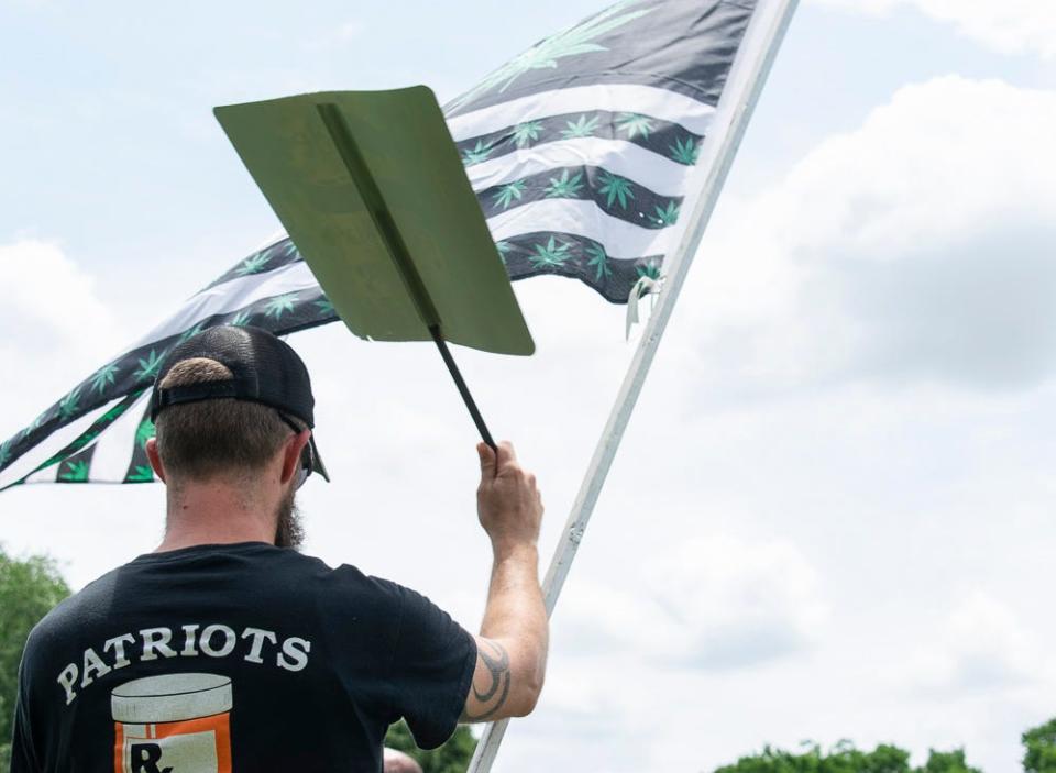 James Baldus of Pike Creek holds a sign in support of legalizing recreational marijuana at a rally outside of Legislative Hall in Dover on Tuesday, June 7, 2022.