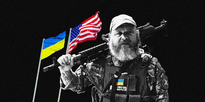Bryan young in dressed in army gear against a black background with the flags of Ukraine and the USA behind him