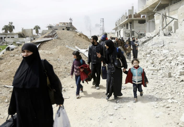 Syrians from rebel-held Eastern Ghouta arrive at a checkpoint on the outskirts of Damascus on March 15, 2018