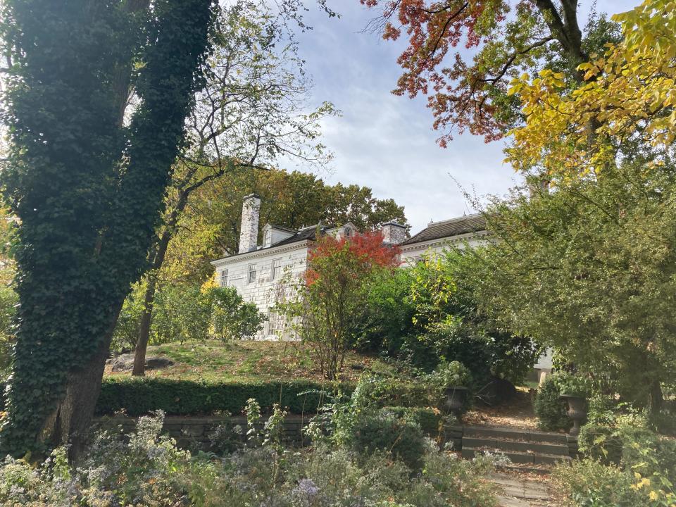 The Morris-Jumel Mansion in upper Manhattan surrounded by trees.