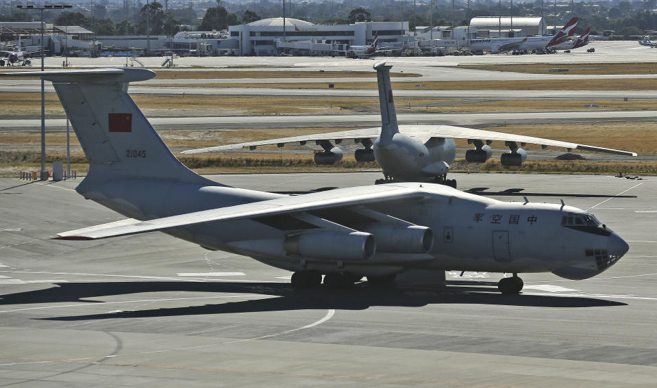 A Chinese Ilyushin IL-76s aircraft taxies past another at Perth Airport, Australia, after returning from ongoing search operations for the missing Malaysia Airlines Flight 370, Saturday, April 12, 2014. With no new underwater signals detected, Australian Prime Minister Tony Abbott said Saturday that the massive search for the Malaysian jet would likely continue "for a long time" as electronic transmissions from the dying black boxes were fading fast. (AP Photo/Rob Griffith, Pool)