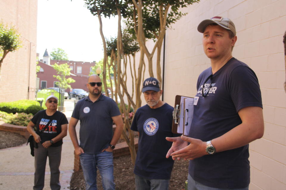 Granville door-knocking volunteers, including first-time canvasser Ellen Hammond to the left, listen to instructions before the Granville County Democratic Party's door-knocking campaign in Oxford, N.C. on Saturday, May 25, 2024. The canvassing event focused on speaking with Democrats or people who typically vote Democrat. (AP Photo/Makiya Seminera)