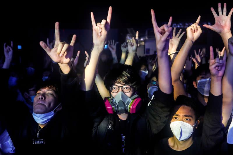 Fans wearing protective masks enjoy a band's performance at Hidden Agenda: This Town Needs (TNN) Live House during the club's last concert as business plummets due to the fear of the coronavirus, in Hong Kong