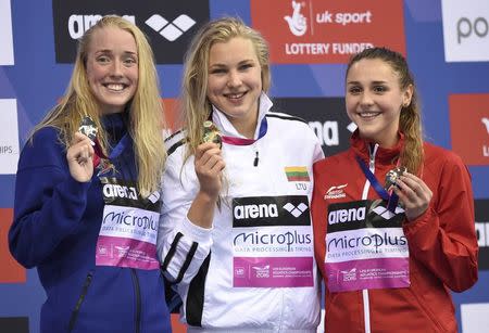 Swimming- European Aquatics Championships- Women's 100m breaststroke final - London, Britain, 18/5/2016. Lituania's Ruta Meilutyte (C) celebrates victory with second placed Hrafnhildu Luthersdottir and Britain's Chloe Tutton on podium. REUTERS/Tony O'Brien