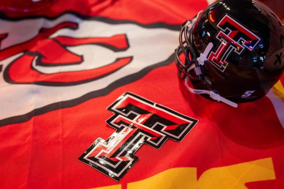 A Texas Tech University mini figurine helmet is displayed alongside a sticker and a Kansas City Chiefs flag by Kansas City Chiefs fan J.R. Morales on Tuesday, Feb. 6, 2024, in Lubbock, Texas.