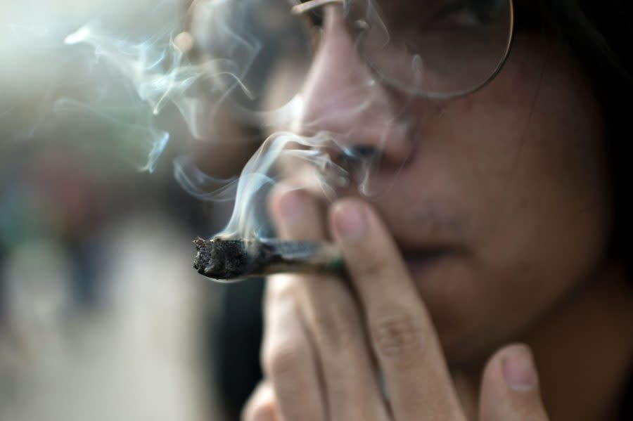 A man smokes a joint during the International Marijuana Day celebration in Santiago, Chile, on April 20, 2023. (Pablo VERA / AFP via Getty Images)