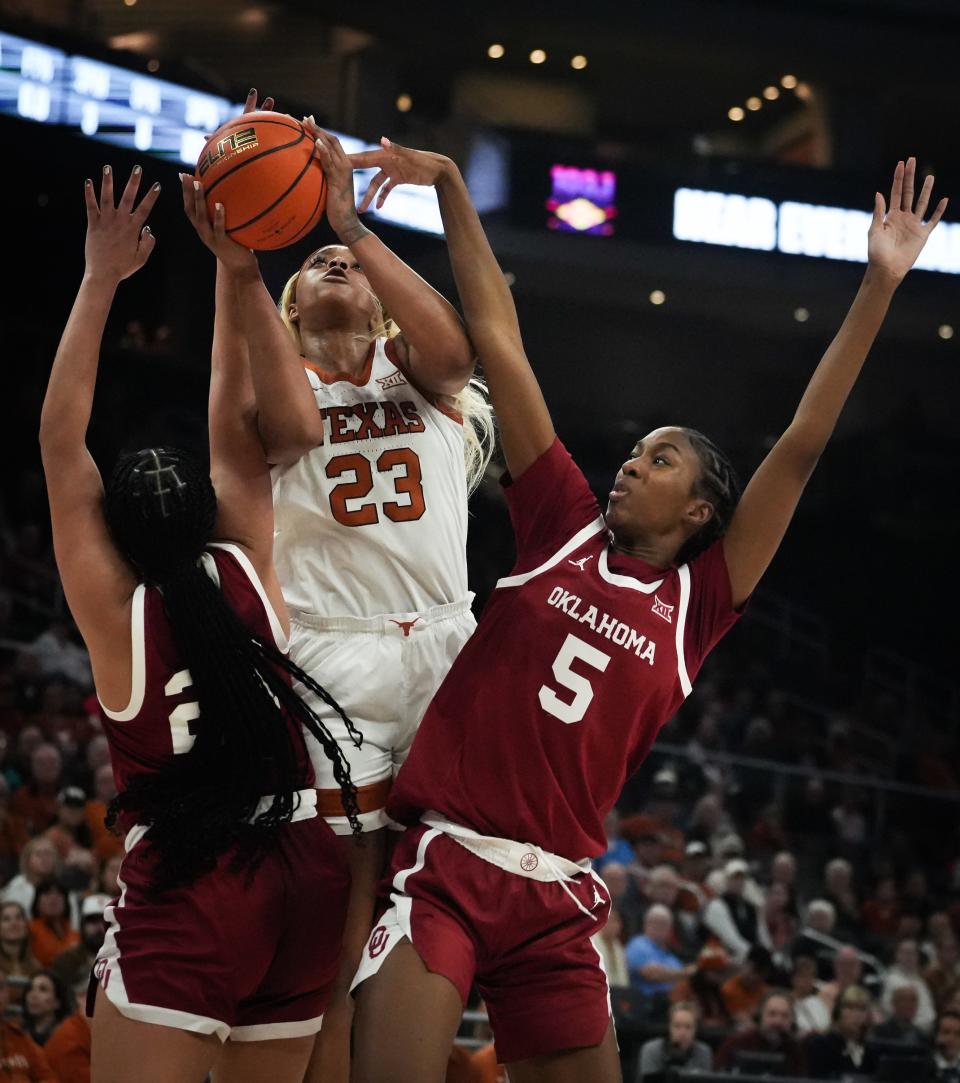 Texas forward Aaliyah Moore splits Oklahoma defenders Kiersten Johnson, right, and Skylar Vann, left, during the first half of their Jan. 24 game at Moody Center, a 91-87 Sooners victory. Texas hasn't lost since, however, and Wednesday night's rematch in Norman, Okla., probably will decide the Big 12 championship.