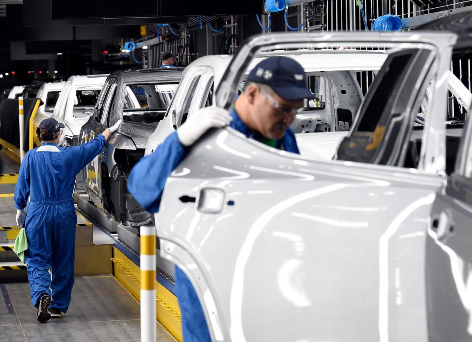 Workers inspect newly painted vehicles at General Motors' manufacturing facility in Spring Hill, Tennessee, on April 6, 2023. Tennessee has four major assembly plants and automotive operations in 88 of 95 counties, according to the state's department of economic and community development.