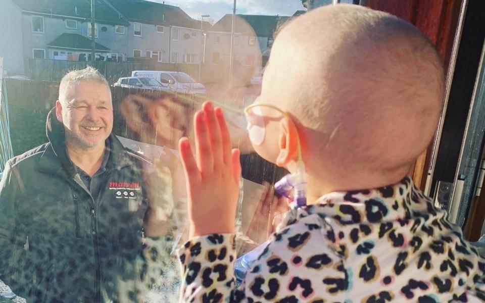 The Hold Still portrait of Mila Sneddon, then four, blowing a kiss to her father, Scott, through the window - Caters News Agency