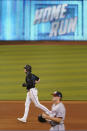 Miami Marlins' Brian Anderson, top, rounds second base after hitting a home run that also scored Garrett Cooper and Jesus Aguilar as Washington Nationals relief pitcher James Bourque, foreground, looks on during the fifth inning of the second game of a baseball doubleheader, Friday, Sept. 18, 2020, in Miami. (AP Photo/Wilfredo Lee)