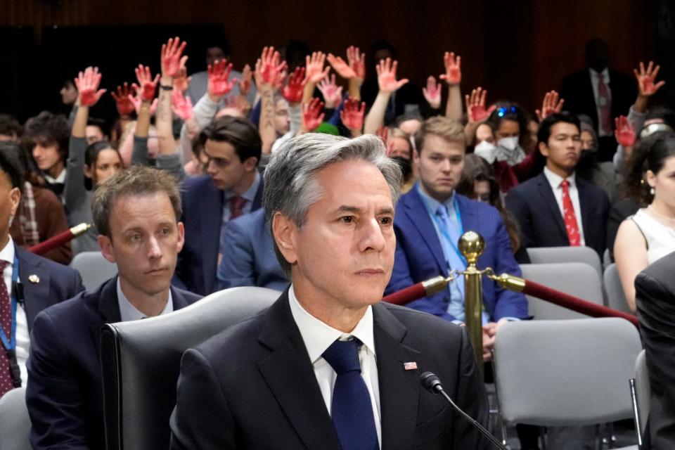 Secretary of State Antony Blinken pauses as protestors interrupt his testimony in Washington, Tuesday, Oct. 31, 2023.