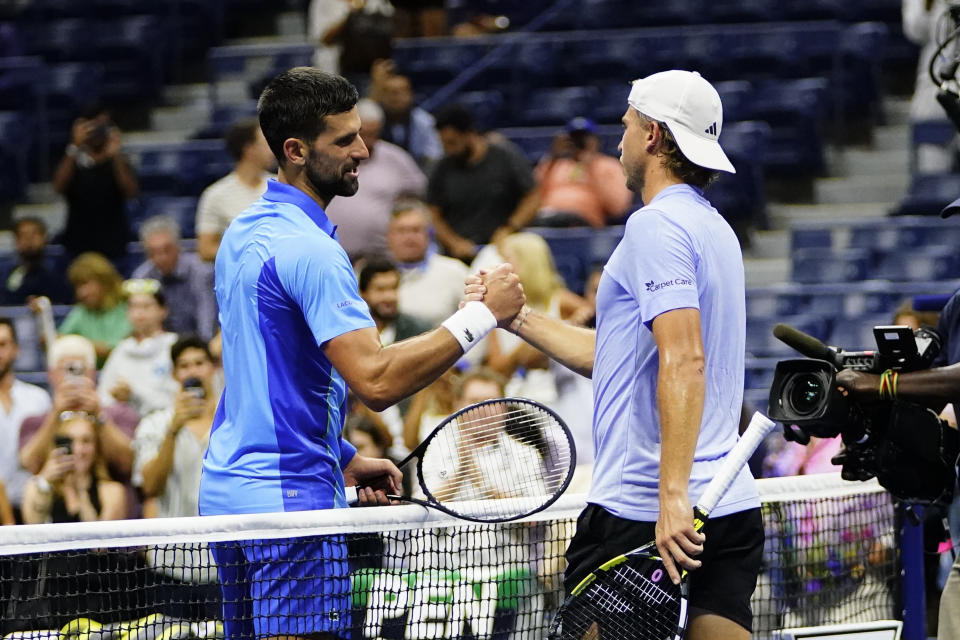 Novak Djokovic, left, of Serbia, shakes hands with Alexandre Muller, of France, after winning their match during the first round of the U.S. Open tennis championships, Tuesday, Aug. 29, 2023, in New York. (AP Photo/Frank Franklin II)