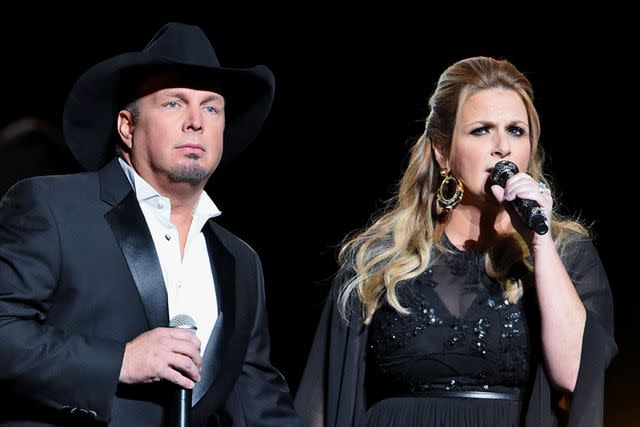 <p>Erika Goldring/FilmMagic</p> Brooks and Trisha Yearwood perform onstage at the 50th annual CMA Awards in Nov. 2016