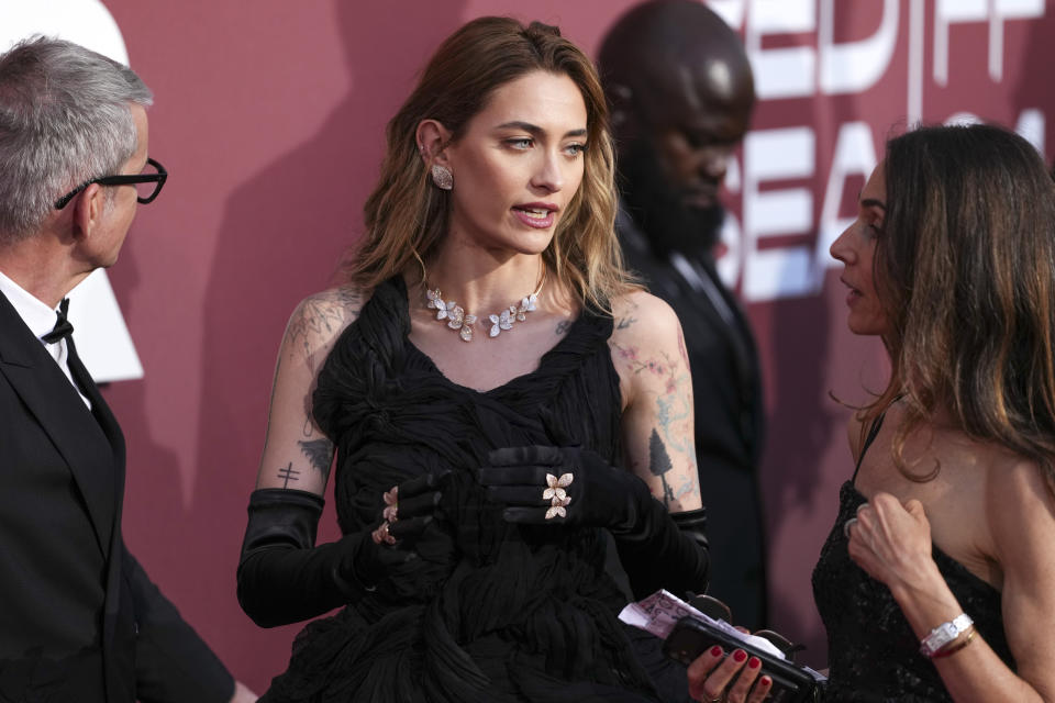 Paris Jackson, center, poses for photographers upon arrival at the amfAR Cinema Against AIDS benefit at the Hotel du Cap-Eden-Roc, during the 77th Cannes international film festival, Cap d'Antibes, southern France, Thursday, May 23, 2024. (Photo by Scott A Garfitt/Invision/AP)