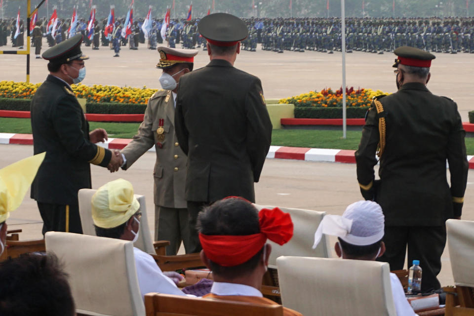 A military commander from Myanmar, 2nd from right, greets guests as they attend an annual parade put on by the military to mark Armed Forces Day in the capital Naypyidaw, March 27, 2021. Amid the military's bloody crackdown on civilians following a February 1 coup, Russia sent its Deputy Defense Minster and China, Vietnam and Thailand sent lower-ranking officials to observe the parade. / Credit: STR/AFP/Getty