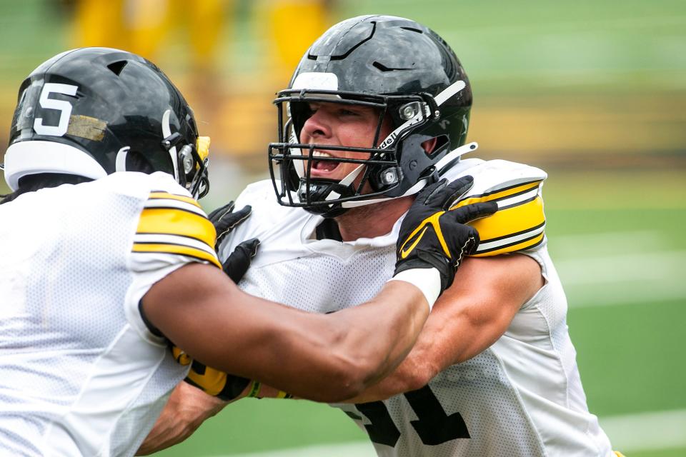 Iowa linebacker Jack Campbell, right, returns to lead a stingy Hawkeyes defense. He led the team in tackles last season.