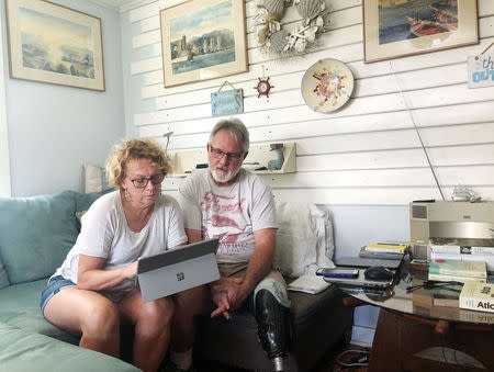 Eileen O’Brien, 65, and Michael O’Brien, 62, read the redacted report by U.S. Special Counsel Robert Mueller on Russian interference in the 2016 U.S. presidential election, at their home in Clearwater, Florida, U.S., April 18, 2019. REUTERS/Letitia Stein