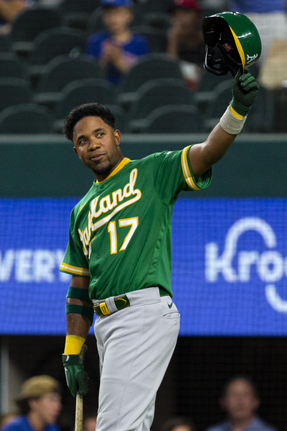 Oakland Athletics' Elvis Andrus (17) raises his helmet to spectators during the second inning of a baseball game against the Texas Rangers, Monday, June 21, 2021, in Arlington, Texas. (AP Photo/Sam Hodde)