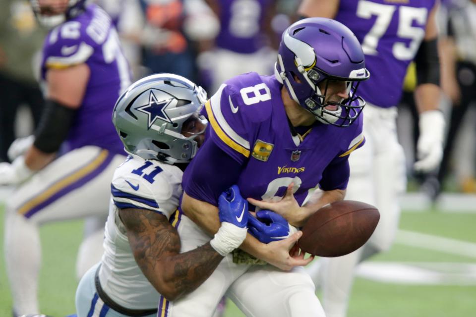 Minnesota Vikings quarterback Kirk Cousins (8) fumbles the ball as he is tackled by Dallas Cowboys linebacker Micah Parsons (11) during the first half of an NFL football game, Sunday, Nov. 20, 2022, in Minneapolis. (AP Photo/Andy Clayton-King)