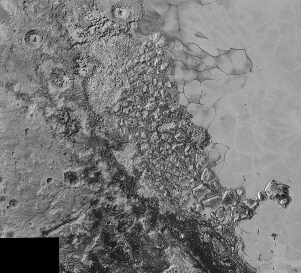 This image of Pluto from New Horizons shows what NASA says is "a large region of jumbled, broken terrain on the northwestern edge of the vast, icy plain informally called Sputnik Planum, to the right."