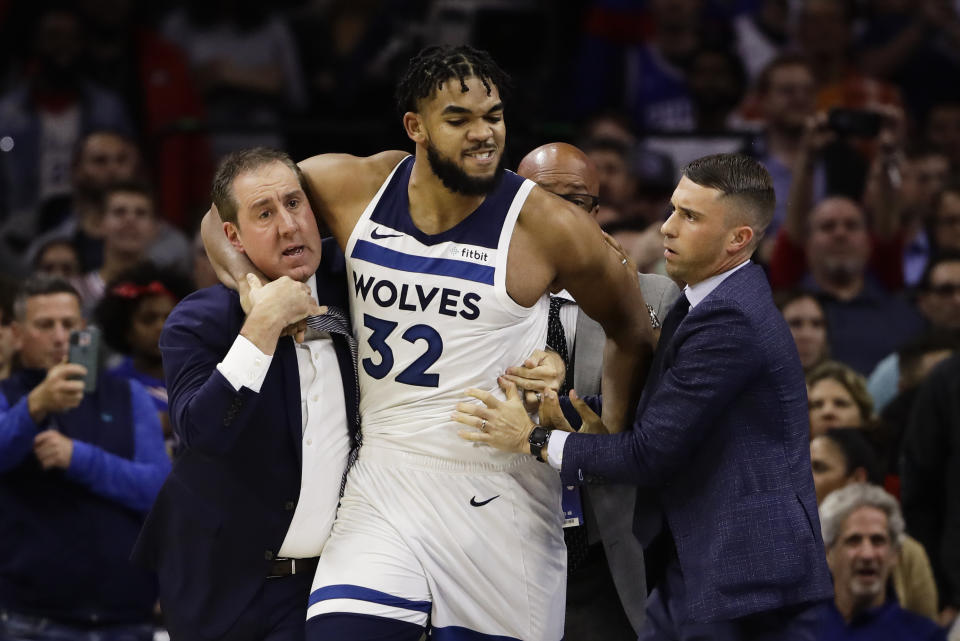 Minnesota Timberwolves' Karl-Anthony Towns is led away after an altercation with Philadelphia 76ers' Joel Embiid during the second half of an NBA basketball game Wednesday, Oct. 30, 2019, in Philadelphia. Both players were ejected. The 76ers won 117-95. (AP Photo/Matt Rourke)