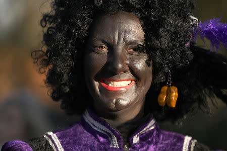 "Zwarte Piet" (Black Pete), who is a Saint Nicholas' assistant is seen during a traditional parade in Zaanstad, Netherlands, November 17, 2018. Picture taken November 17, 2018. REUTERS/Eva Plevier