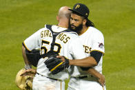 Pittsburgh Pirates relief pitcher Richard Rodriguez, right, hugs catcher Jacob Stallings after getting the final out of a baseball game against the San Diego Padres in Pittsburgh, Tuesday, April 13, 2021. The Pirates won 8-4.(AP Photo/Gene J. Puskar)