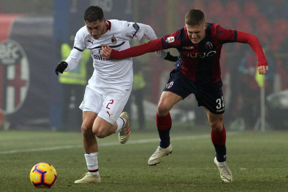 Milan's Davide Calabria, left, and Bolognas Mattias Svanberg in action during the Italian Serie A soccer match between Bologna and Milan at "Dall'Ara" stadium in Bologna, Italy, Tuesday, Dec. 18, 2018. (Giorgio Benvenuti/ANSA via AP)