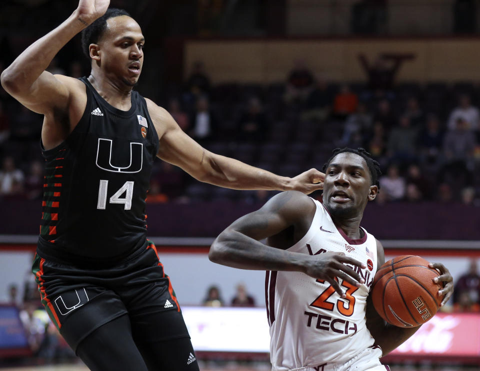 Virginia Tech's Tyrece Radford (23) drives past Miami's Rodney Miller, Jr. (14) during the first half of an NCAA college basketball game, Wednesday, Feb. 19, 2020 in Blacksburg, Va. (Matt Gentry/The Roanoke Times via AP)