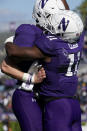 Northwestern running back Andrew Clair, right, celebrates with quarterback Ryan Hilinski after scoring a touchdown during the second half of an NCAA college football game against Rutgers in Evanston, Ill., Saturday, Oct. 16, 2021. Northwestern won 21-7. (AP Photo/Nam Y. Huh)