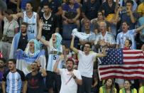 2016 Rio Olympics - Basketball - Quarterfinal - Men's Quarterfinal USA v Argentina - Carioca Arena 1 - Rio de Janeiro, Brazil - 17/8/2016. Team Argentina fans, with one Team USA fan amongst them, cheer during the game. REUTERS/Mariana Bazo