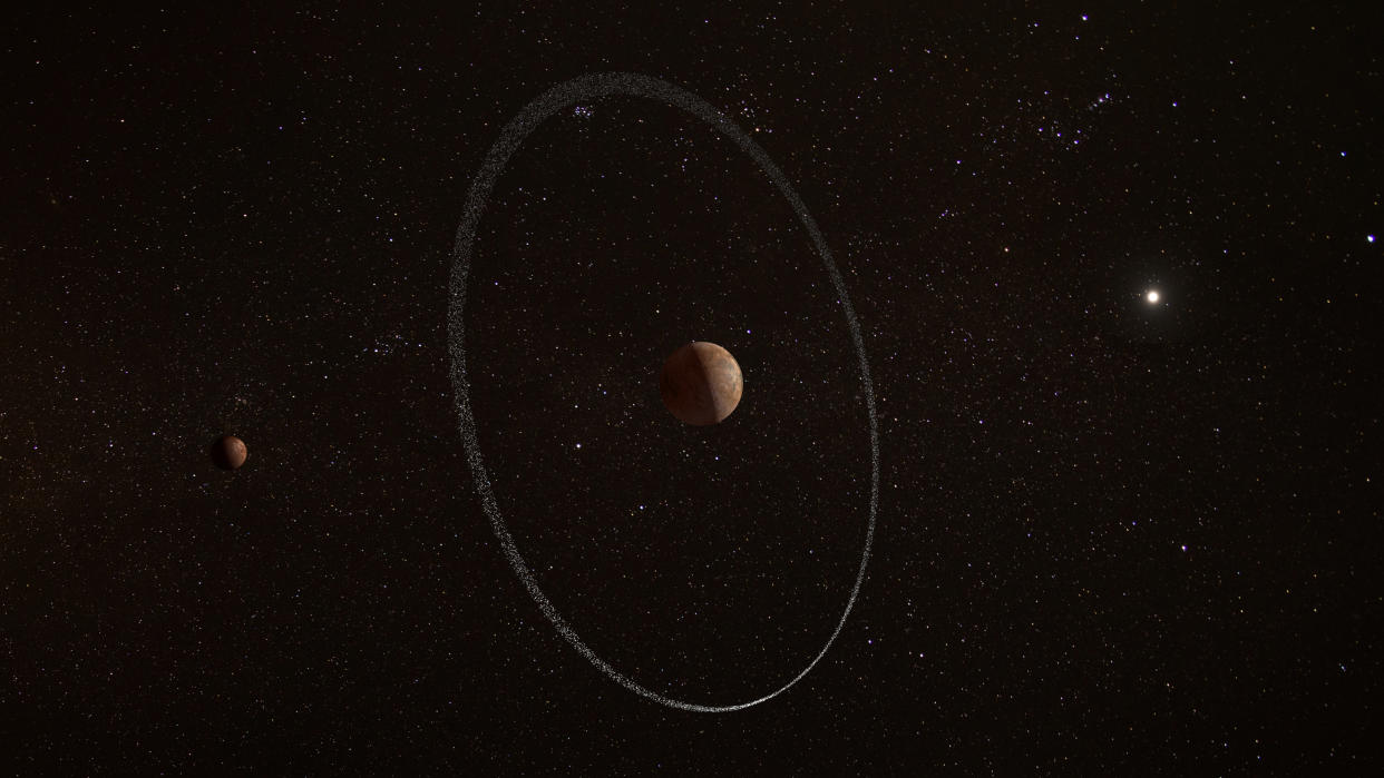 An image of Quaoar surrounded by a thin ring.