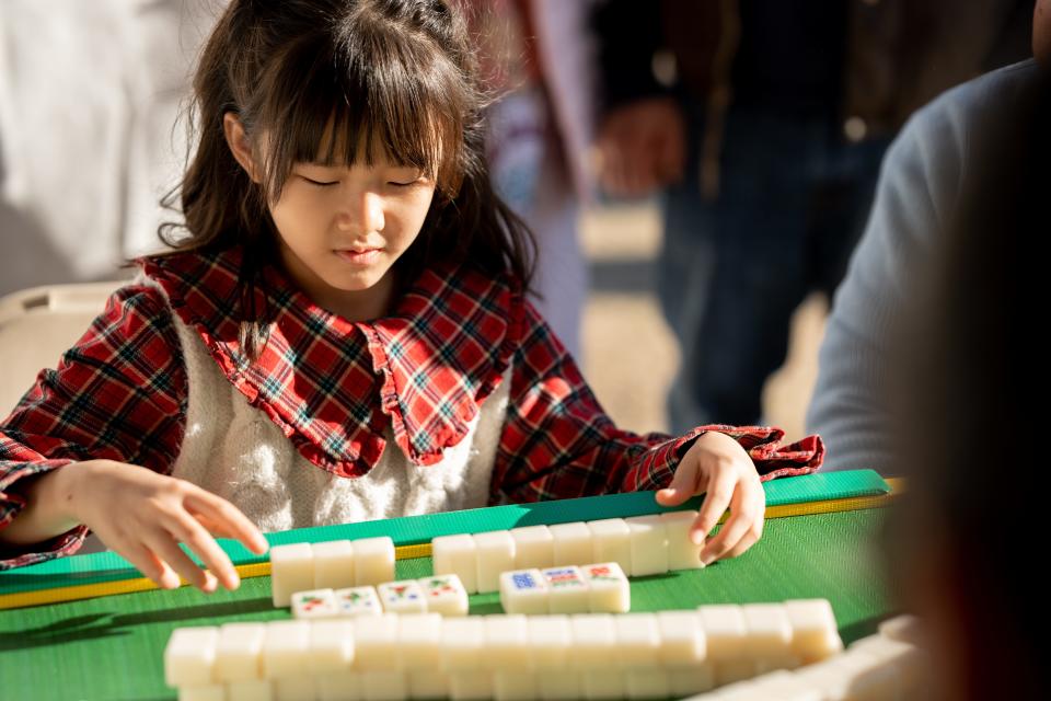 Eunice Huang plays mahjong at the Chinese Culture and Cuisine Festival on Jan. 21 in Phoenix.
