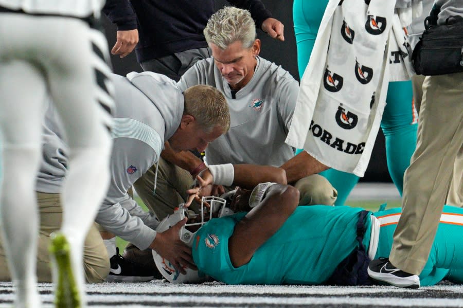 Miami Dolphins quarterback Tua Tagovailoa is examined during the first half of the team’s NFL football game against the Cincinnati Bengals, Thursday, Sept. 29, 2022, in Cincinnati. (AP Photo/Jeff Dean)