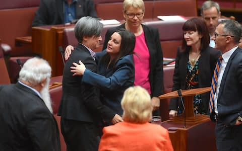 Jacqui Lambie is hugged by other senators after delivering a statement regarding her resignation  - Credit: Reuters