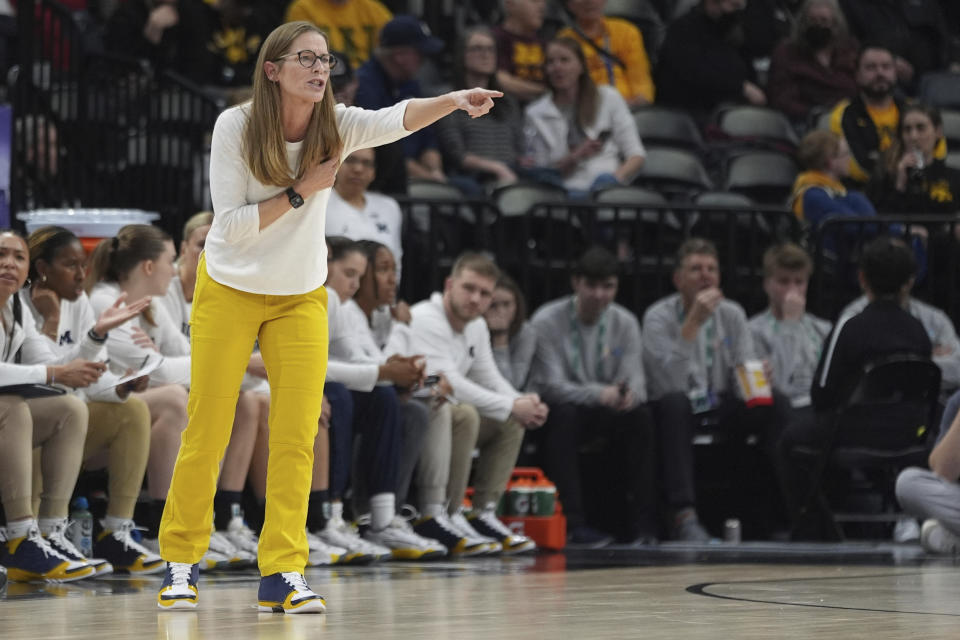 Michigan coach Kim Barnes Arico points during the first half of the team's NCAA college basketball game against Indiana in the quarterfinals of the Big Ten women's tournament Friday, March 8, 2024, in Minneapolis. (AP Photo/Abbie Parr)