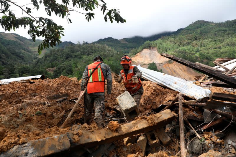 Soldiers work at an area hit by a mudslide, caused by heavy rains brought by Storm Eta, as the search for victims continue in the buried village of Queja