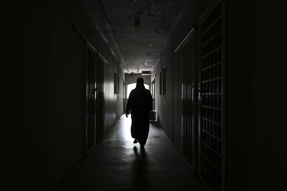 Rohingya child bride, F, age 16, walks down the hallway of an apartment complex in Kuala Lumpur, Malaysia, on Oct. 5, 2023. The complex houses several underage Rohingya girls who are married to older men. F came to Malaysia from Myanmar amid escalating violence from the military in her village. She married her husband the same day they met. "I wasn't ready to be married, but I didn't have a choice," she said. (AP Photo/Victoria Milko)