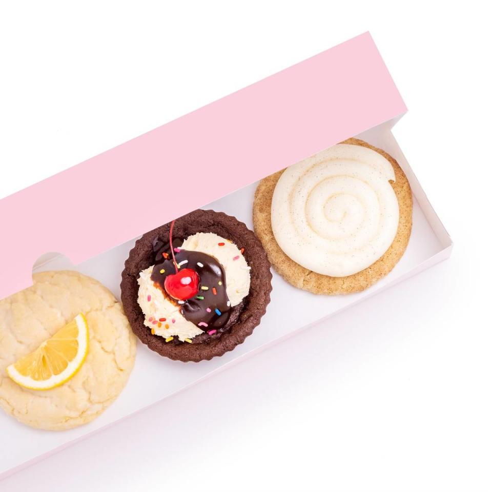 A variety of cookies are displayed in one of Crumbl Cookies’ signature pink oblong boxes. The popular chain is opening a location in Paso Robles on Friday, March 31, 2023.