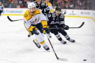 Nashville Predators left wing Filip Forsberg, front, is pursued by New Jersey Devils center Nico Hischier (13) during the first period of an NHL hockey game in Newark, N.J., Sunday, April 7, 2024. (AP Photo/Peter K. Afriyie)