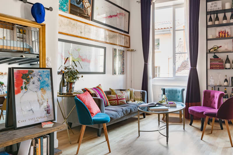 Colorful chairs below-framed wall art.