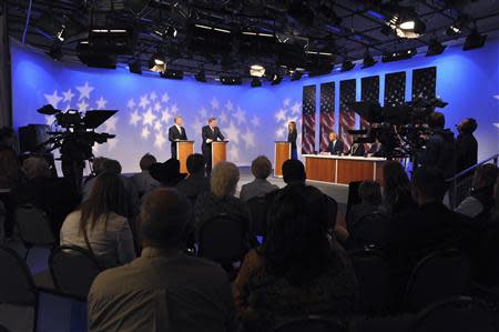 Challenger Bryan Smith (L) and incumbent Congressman Mike Simpson (R-ID) participated in a televised debate for the upcoming Republican primary election at the studios of Idaho Public Television in Boise, Idaho May 11, 2014. REUTERS/Patrick Sweeney