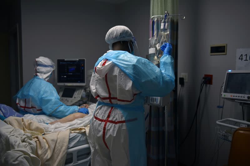 FILE PHOTO: Healthcare workers treat COVID-19 patients on New Year’s Eve in Houston