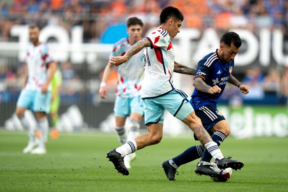 Chicago Fire midfielder Federico Navarro (31) fouls FC Cincinnati midfielder Luciano Acosta (10) while he handles the ball in the first half of the MLS match at TQL Stadium in Cincinnati on Saturday, June 3, 2023.